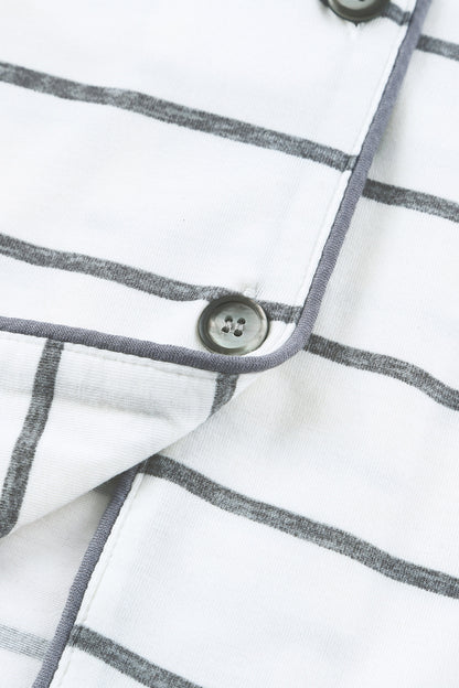 close-up on fabric of a white cotton pajama with stripes