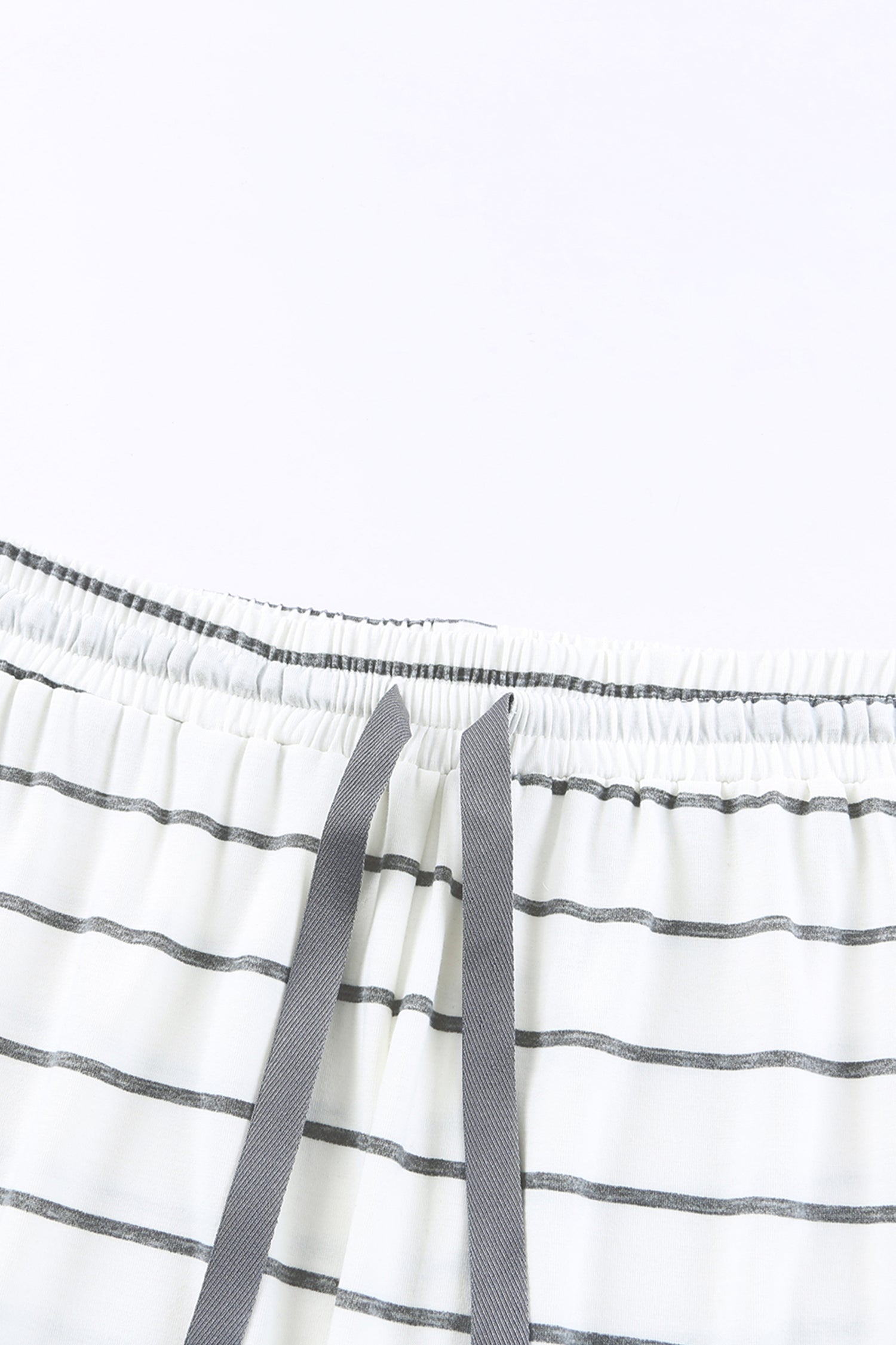 close-up on fabric of a white cotton pajama with stripes